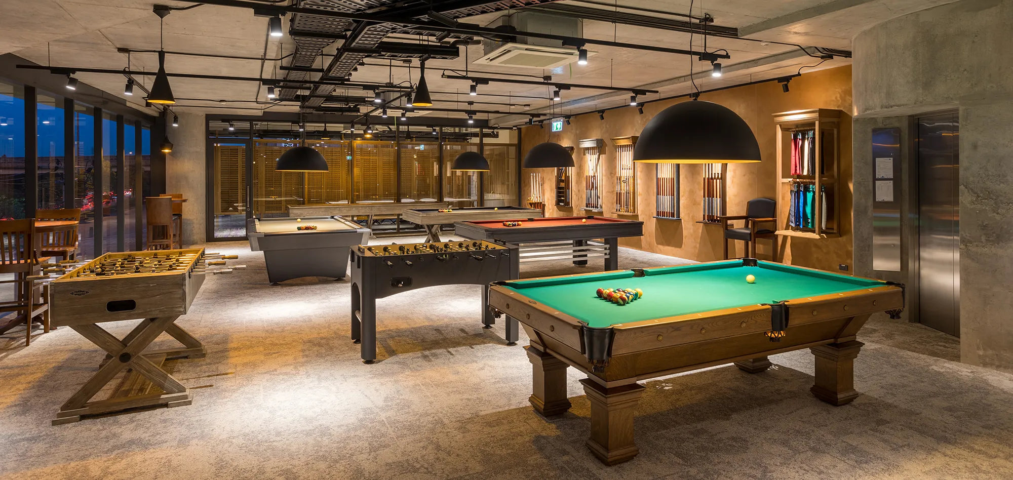 Billiard shop with tables, cues, apparel and nice soft lighting